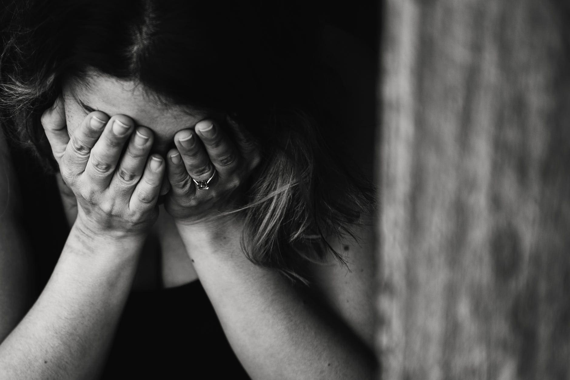 grayscale photography of crying woman